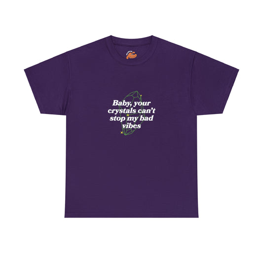 Gildan 5000 Unisex Heavy Cotton Purple Colored T-Shirt with this phrase written on the front side: Baby, your crystals can't stop my bad vibes. (There is a line art of a crystal on the background behind the phrase)